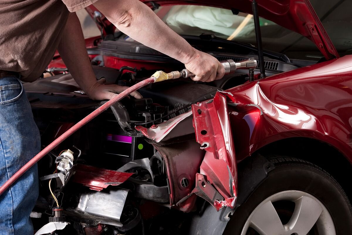 Technician repairing a car body panel