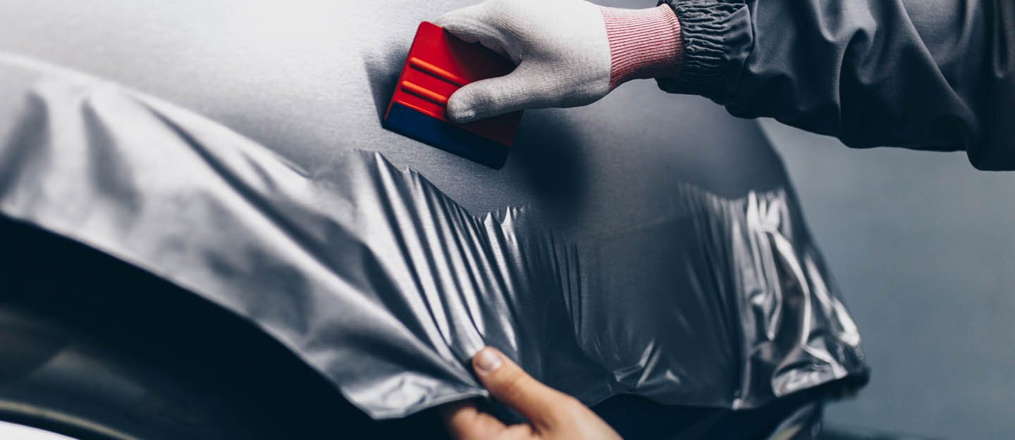 Car being wrapped in a custom vinyl colour